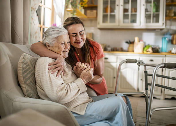 Aged care worker warmly supporting an older woman at home